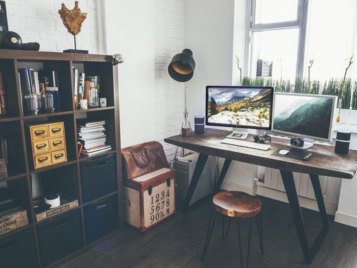 Home office with a bookcase, a desk and a computer