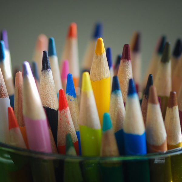 Glass jar full of sharpened colored pencils
