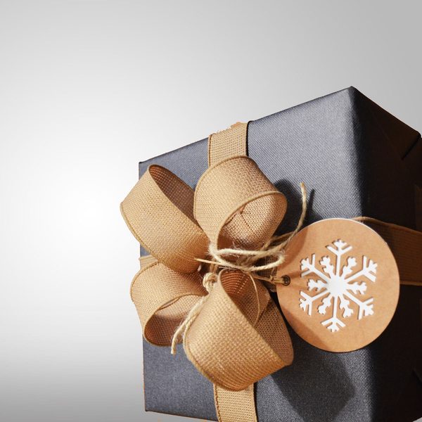 Dark gift box tied with a tan ribbon bow