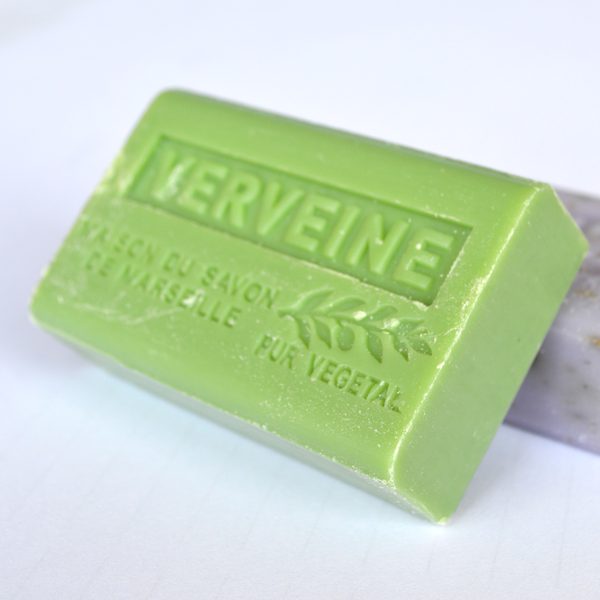 Two bars of green and lavender soap on a white background