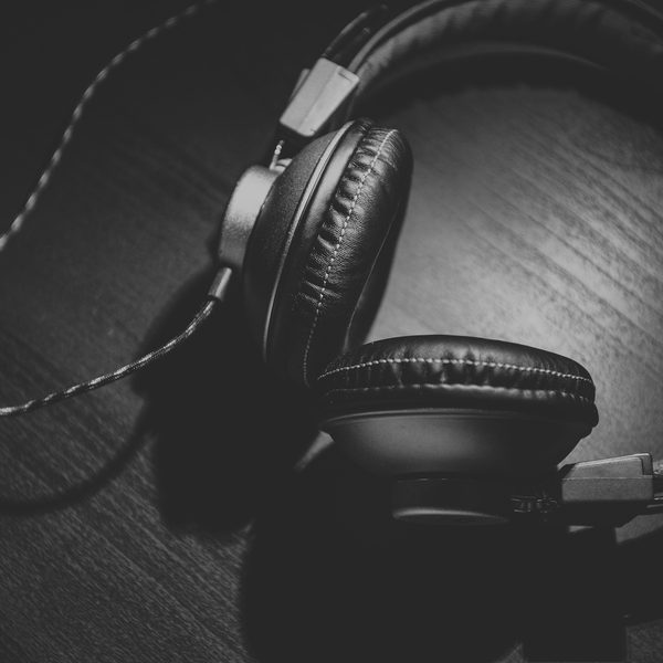 Black over-ear headphones on a wooden table