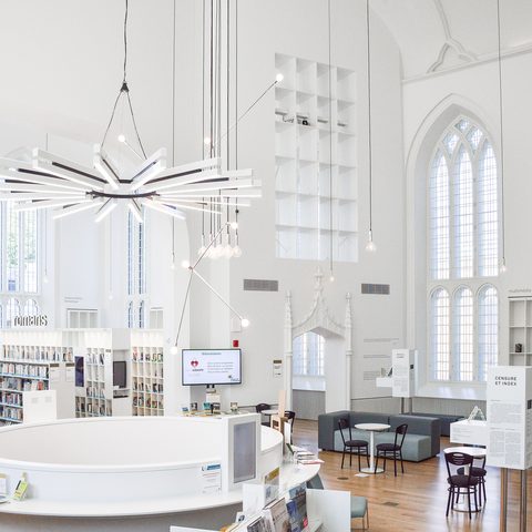 Bright white library with tall arched windows