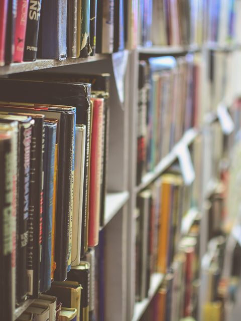 Long rows of colorful books on library shelves