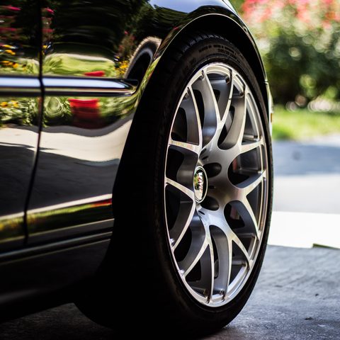 Close view of a silver alloy wheel on a black car
