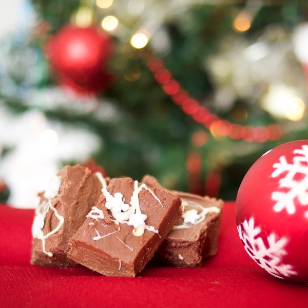 Pieces of chocolate fudge next to a red snowflake bauble