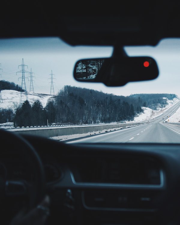 View through a car windshield onto a snowy winter road