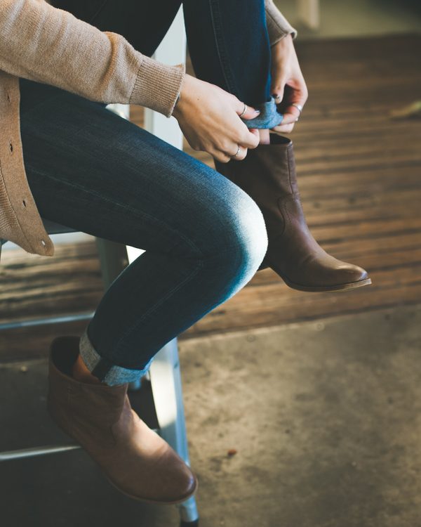 Brown leather ankle boots worn with slim blue jeans