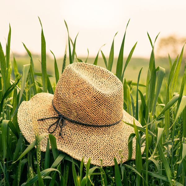 A wide straw sun hat on a sunny beach