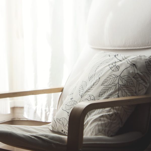 A linen cushion with a leaf print on a bentwood armchair