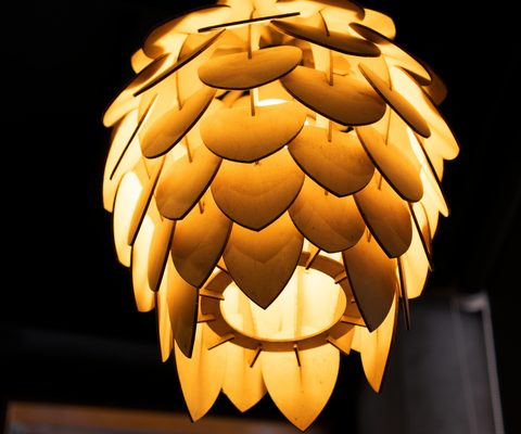 Copper pendant lamp with leaf shaped shades glowing warm