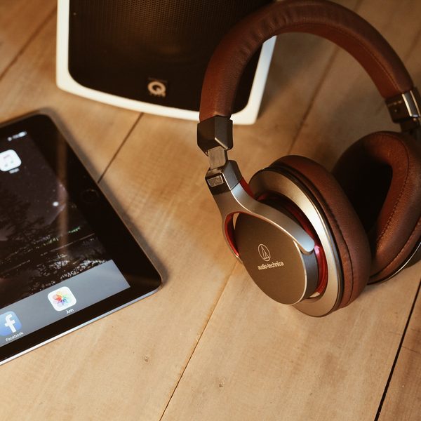 Brown leather headphones on a wooden desk