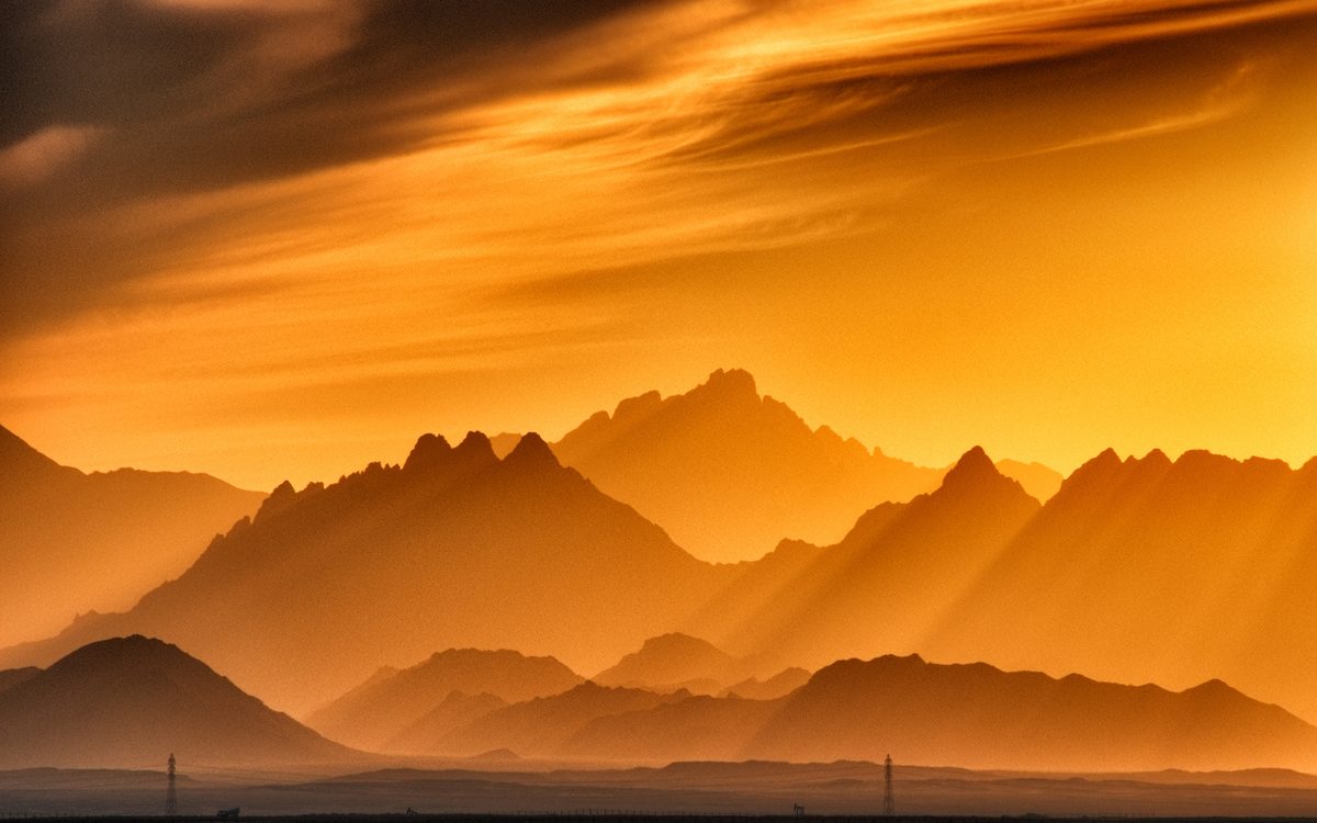 Layers of mountain ridges in an orange evening haze