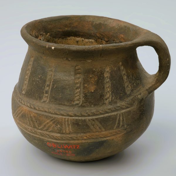 Round brown clay jug with a single handle