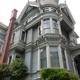 Tall grey Victorian house with a corner tower