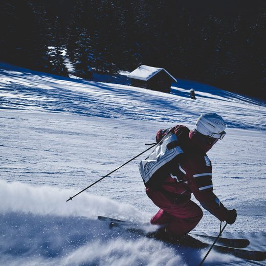 Skier carving a turn in deep powder snow