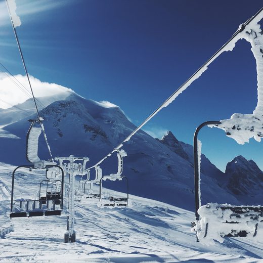 Chairlift rising over a snowy mountain slope
