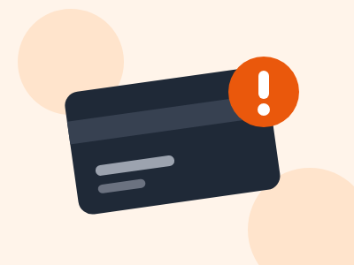 Dark payment card with an orange warning sign