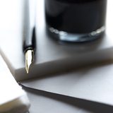Fountain pen resting on white paper