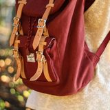Red canvas backpack with leather straps
