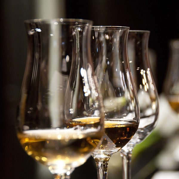 Tulip glasses of golden white wine in warm low light