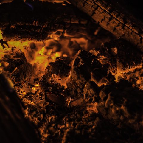 Glowing embers in a wood fire